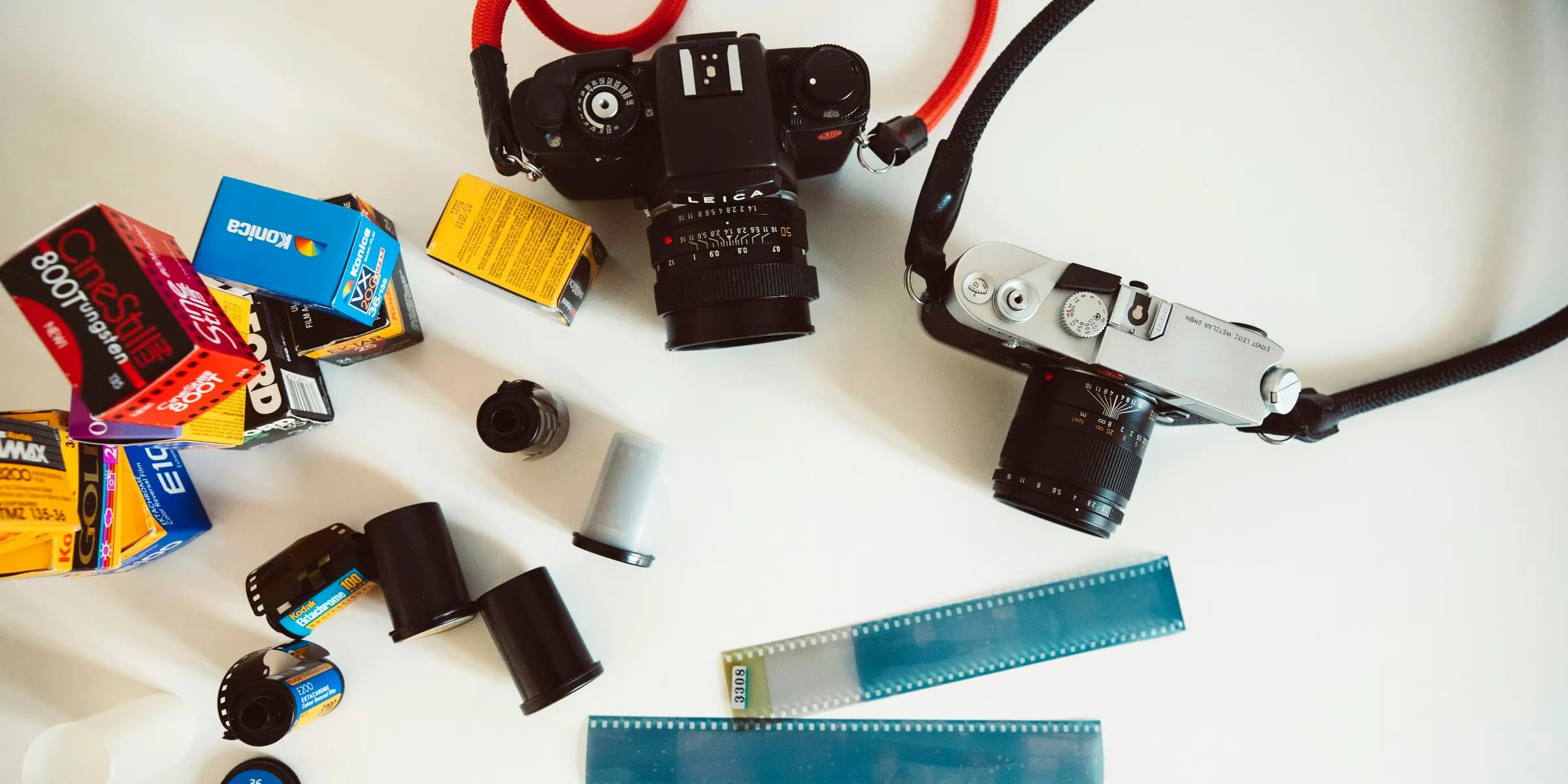 a white table topped with a camera and other items