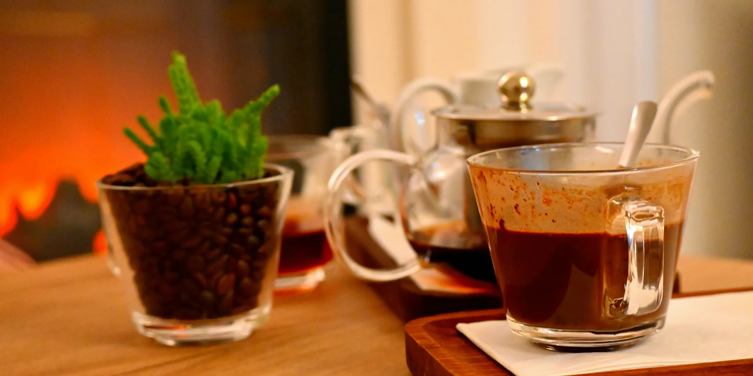 A wooden table topped with cups filled with liquid