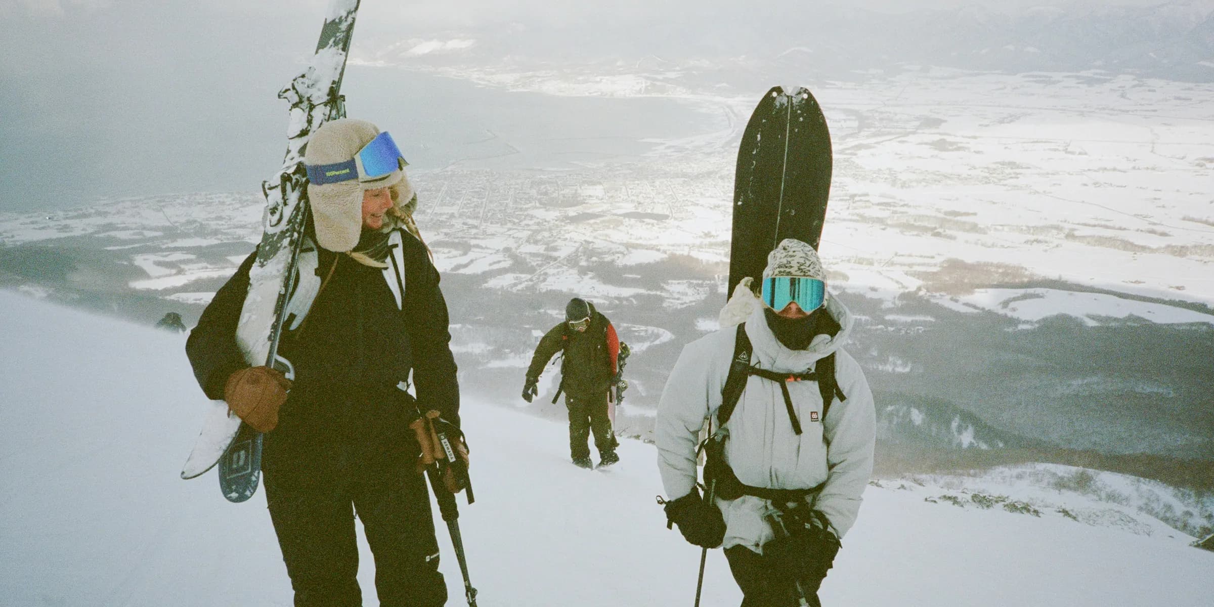 a group of people walking up a snow covered slope