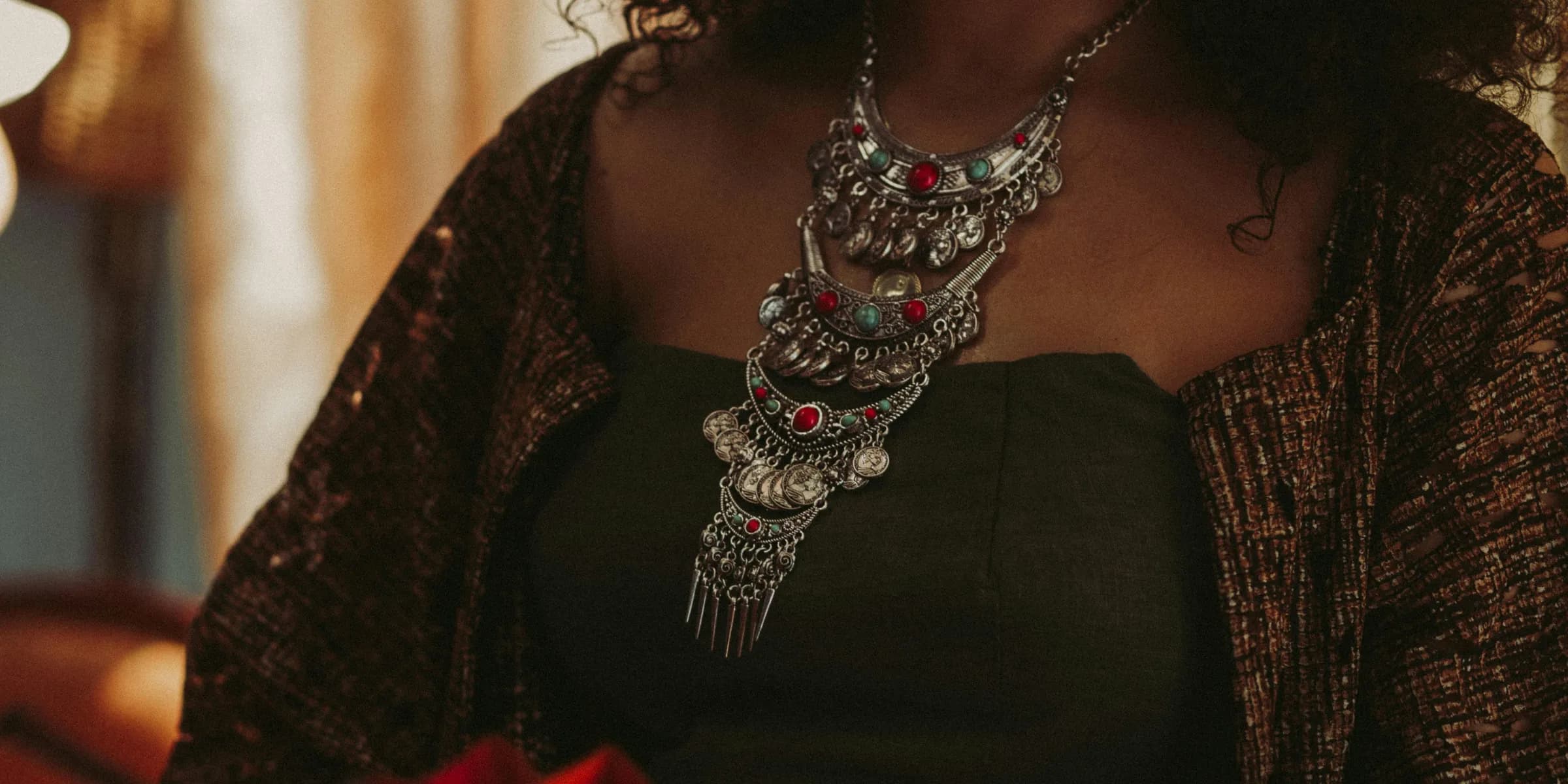 woman wearing silver-colored bib necklace