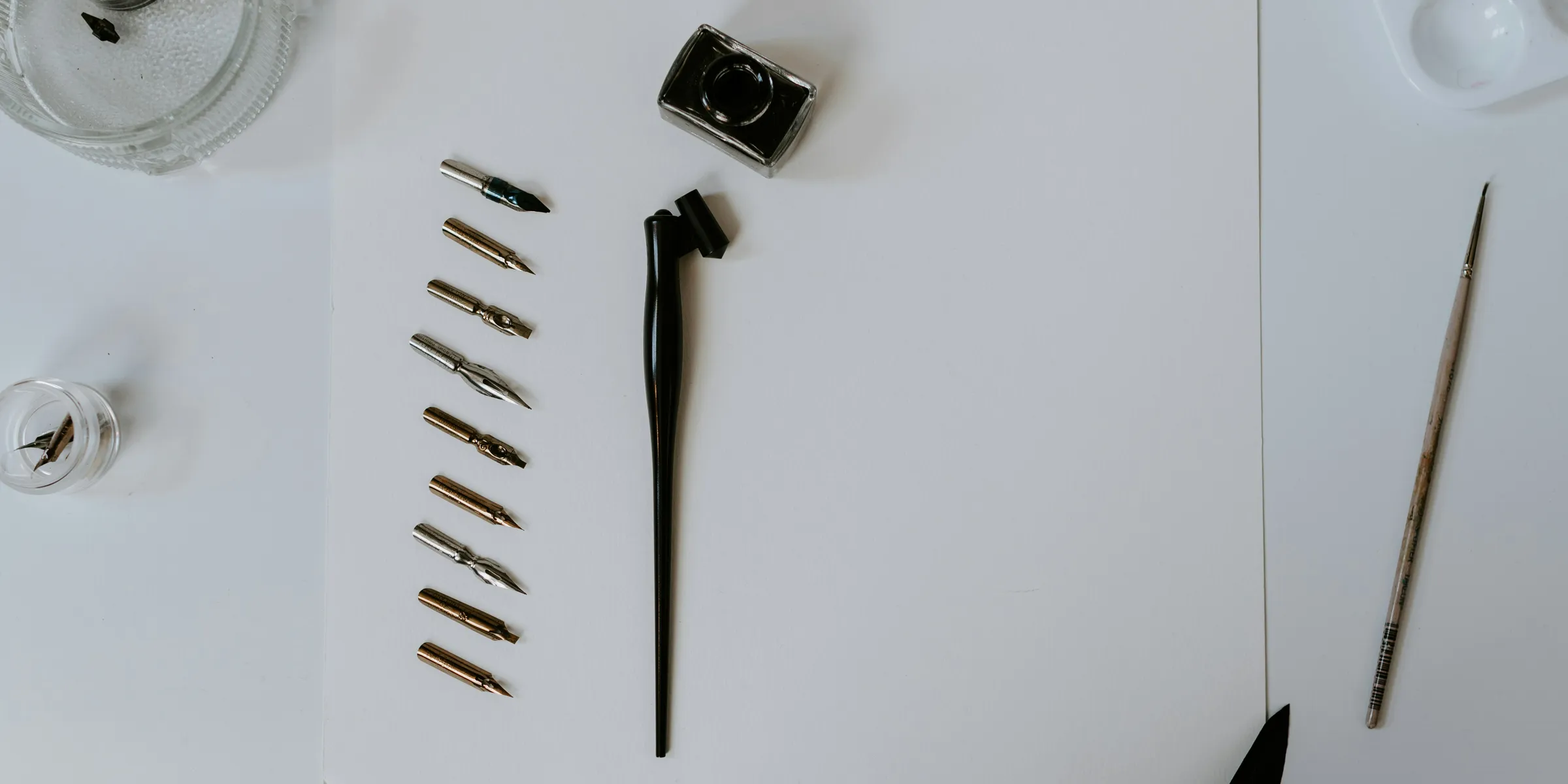 a white table topped with lots of art supplies