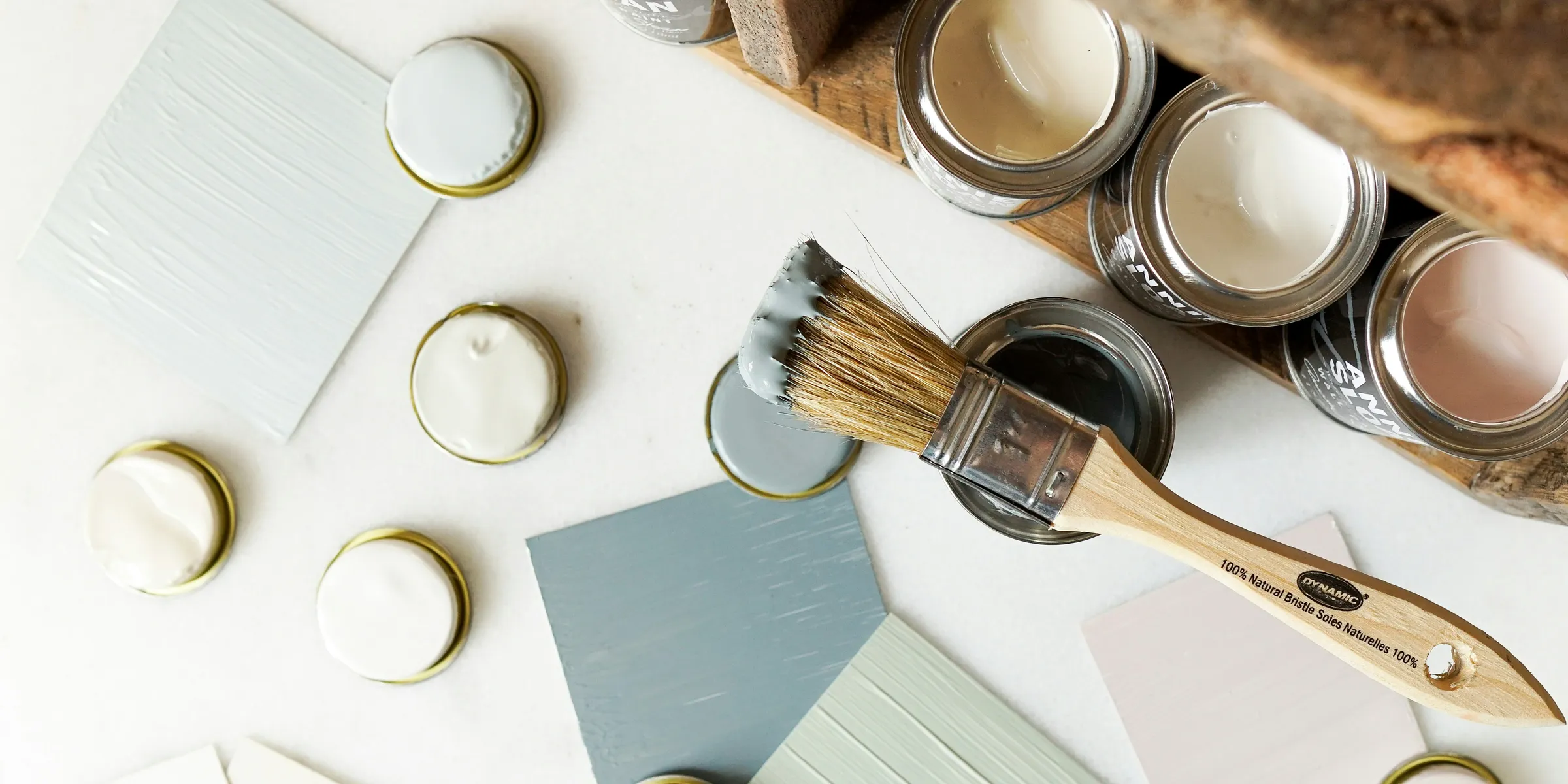 some paint and some brushes on a table