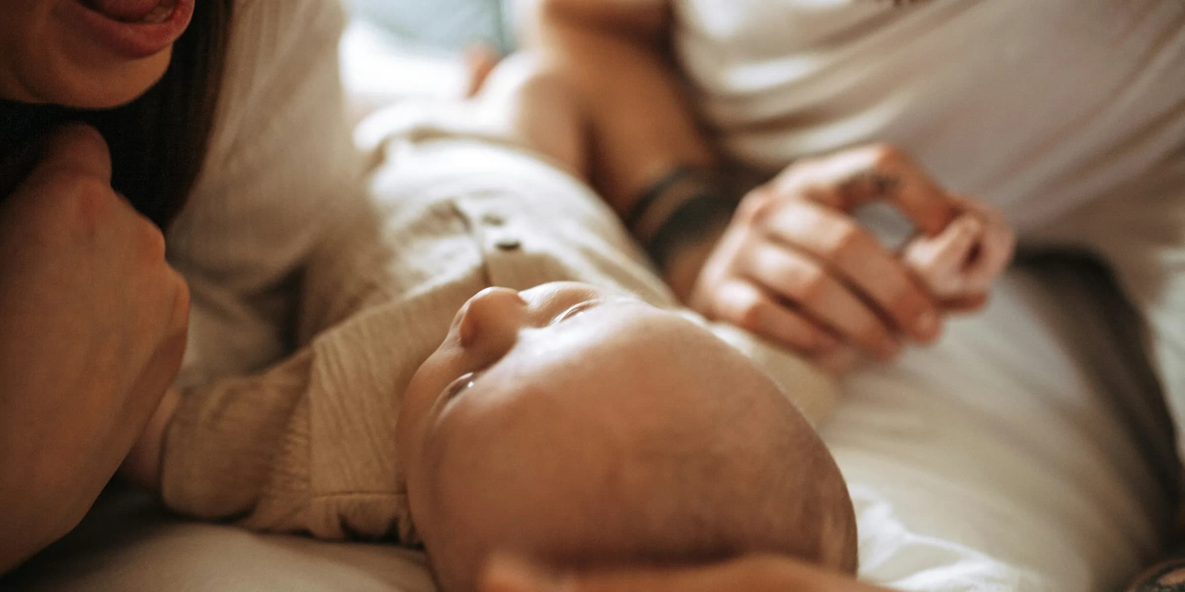 a man and woman holding a baby in their arms