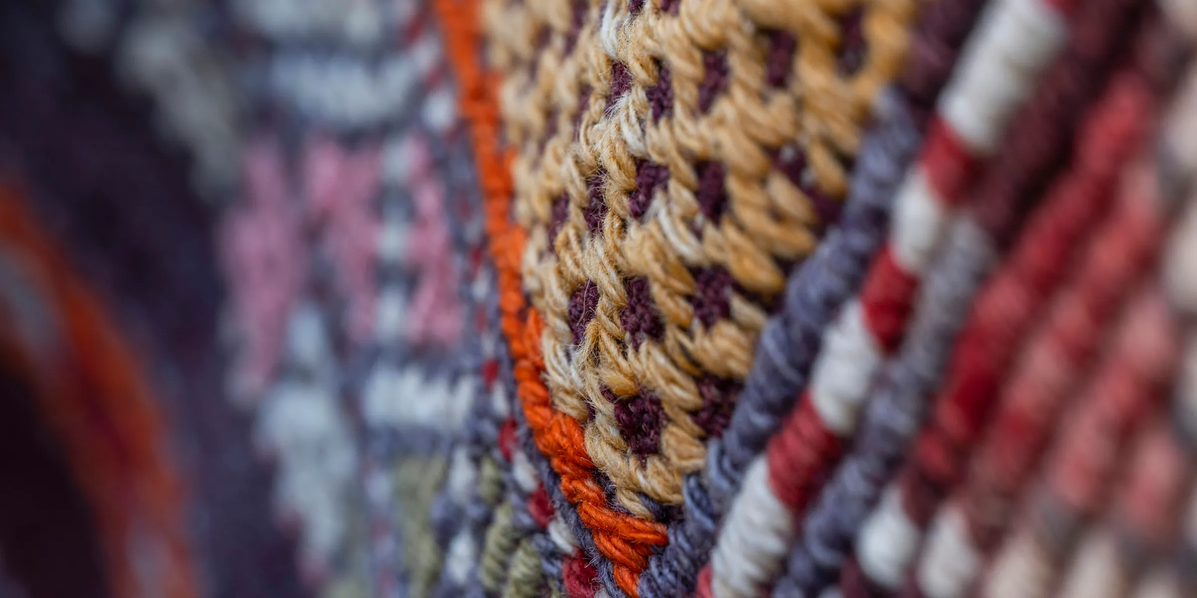 Close-up of colorful woven fabric with intricate patterns.