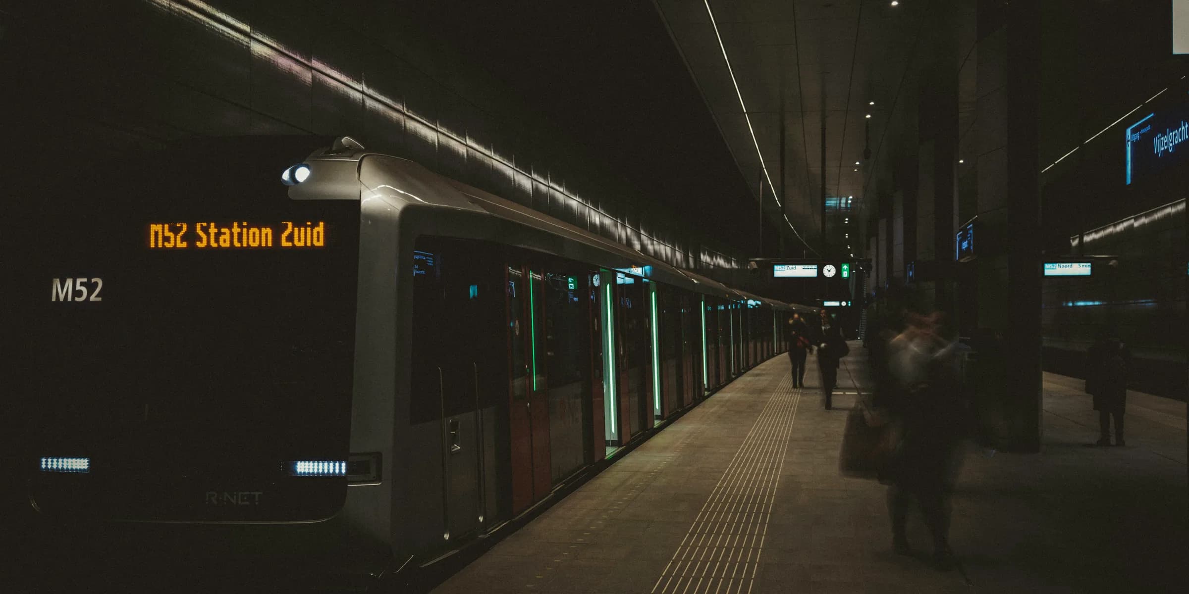 people standing beside train displaying M52 Station