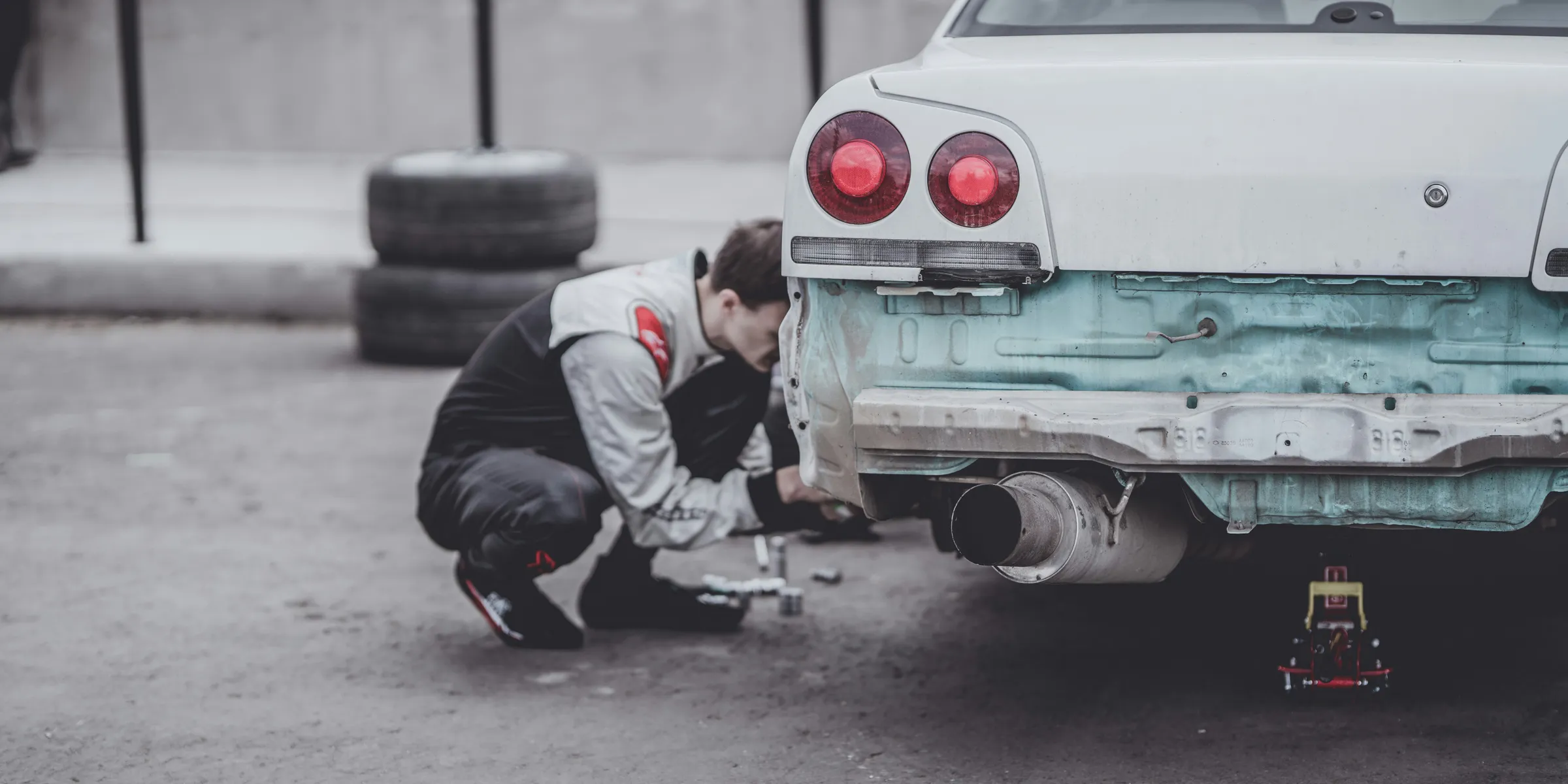 man fixing car