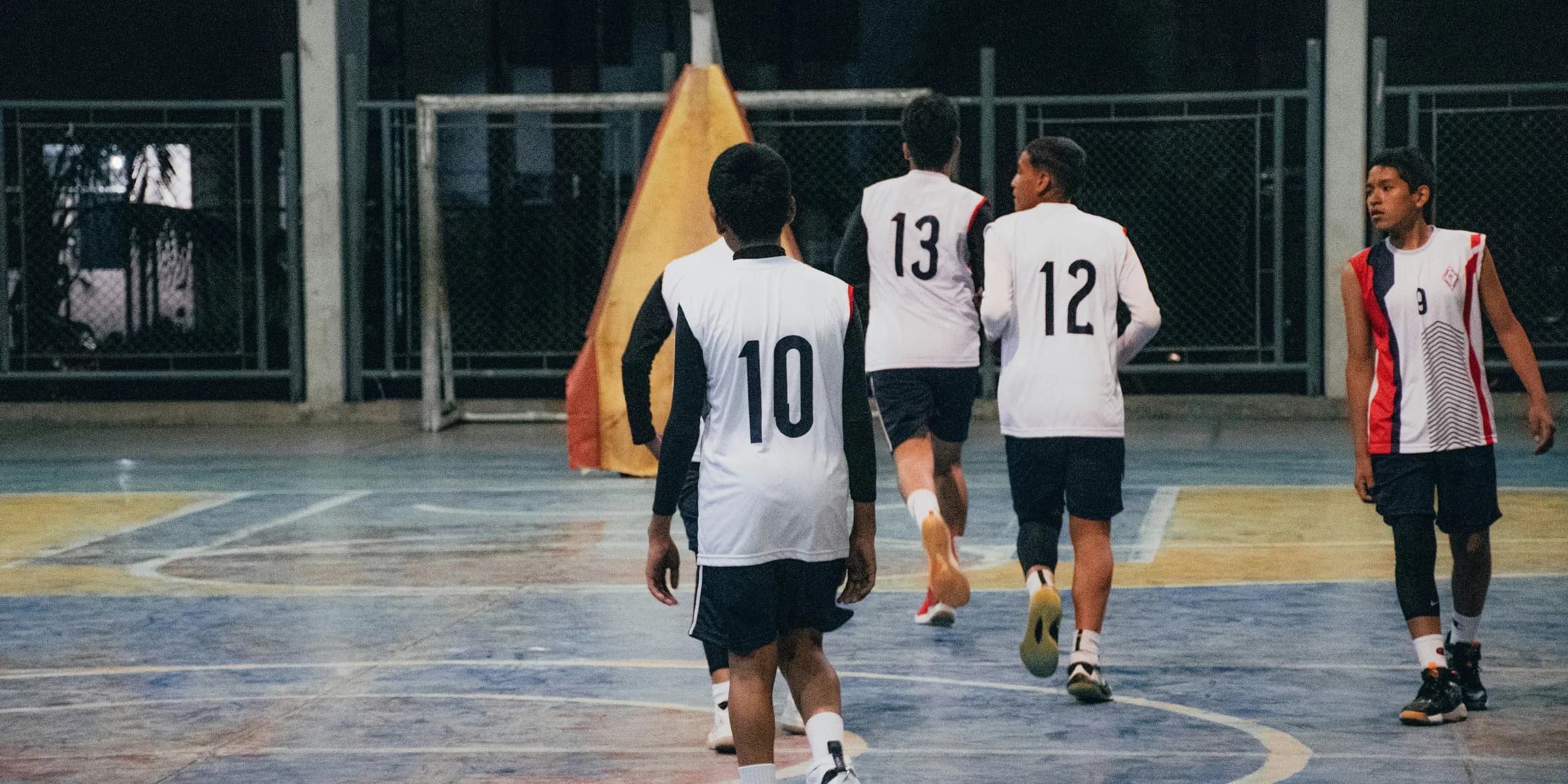 A group of young men playing a game of basketball