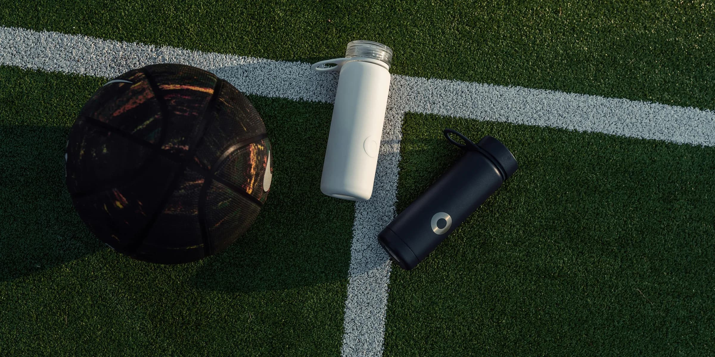 a soccer ball and a water bottle on a soccer field