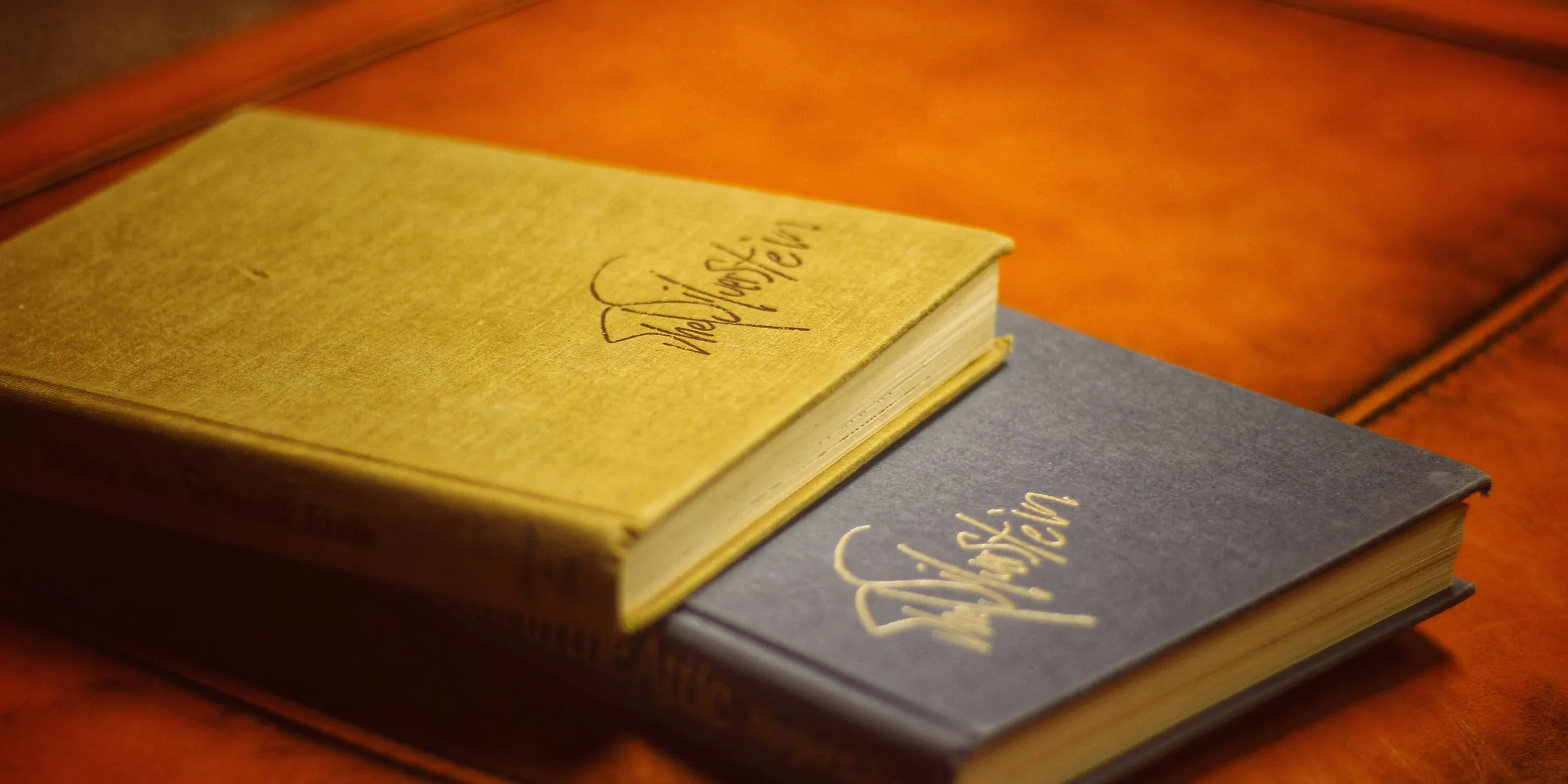 two beige and black books