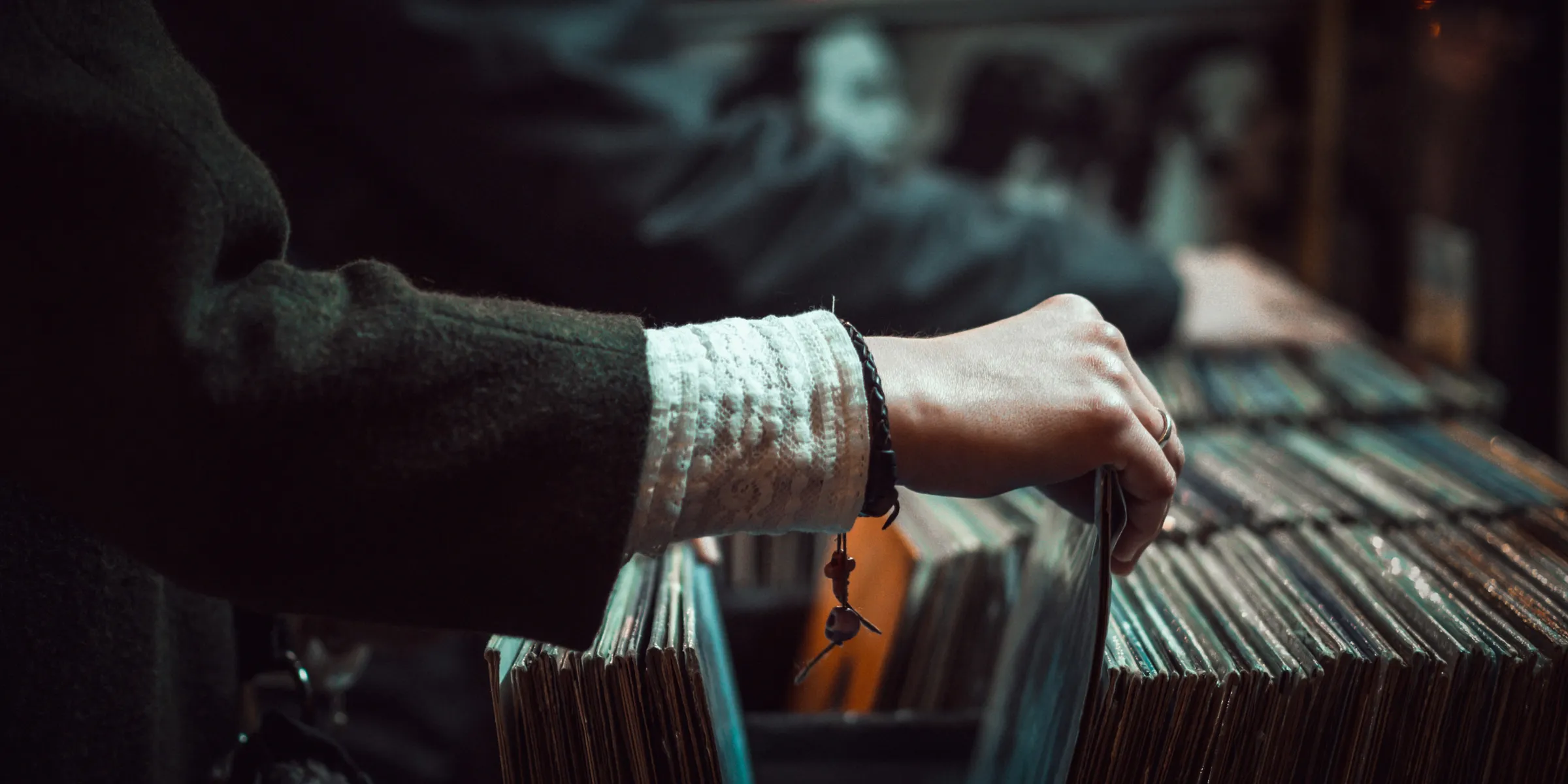 person picking up the music record