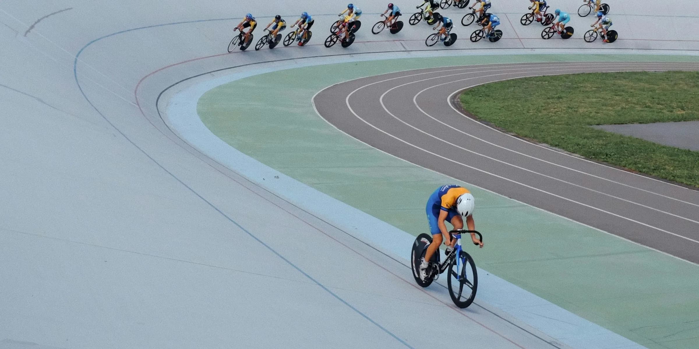 A group of people riding bikes on a track