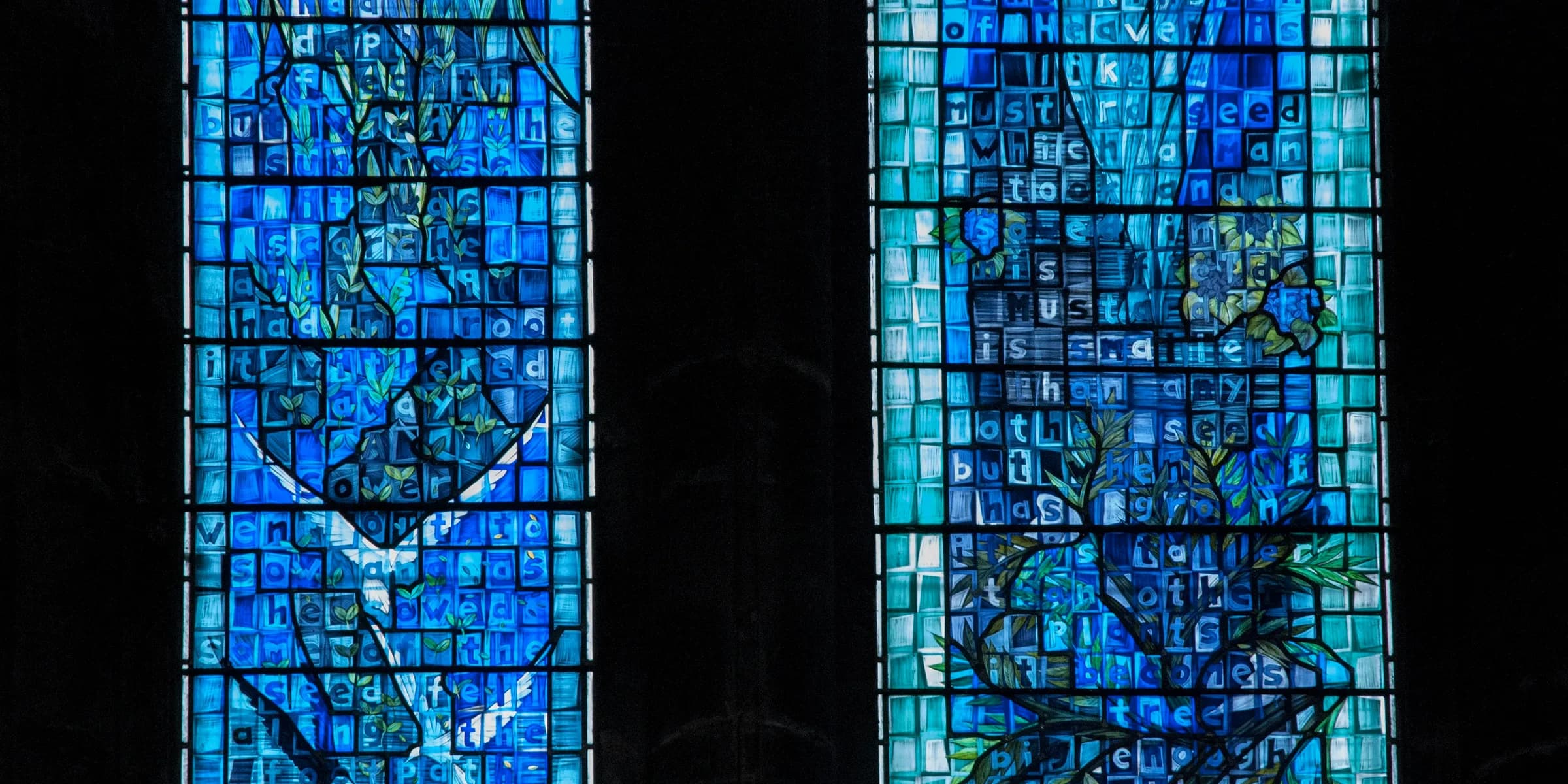 two stained glass windows in a church