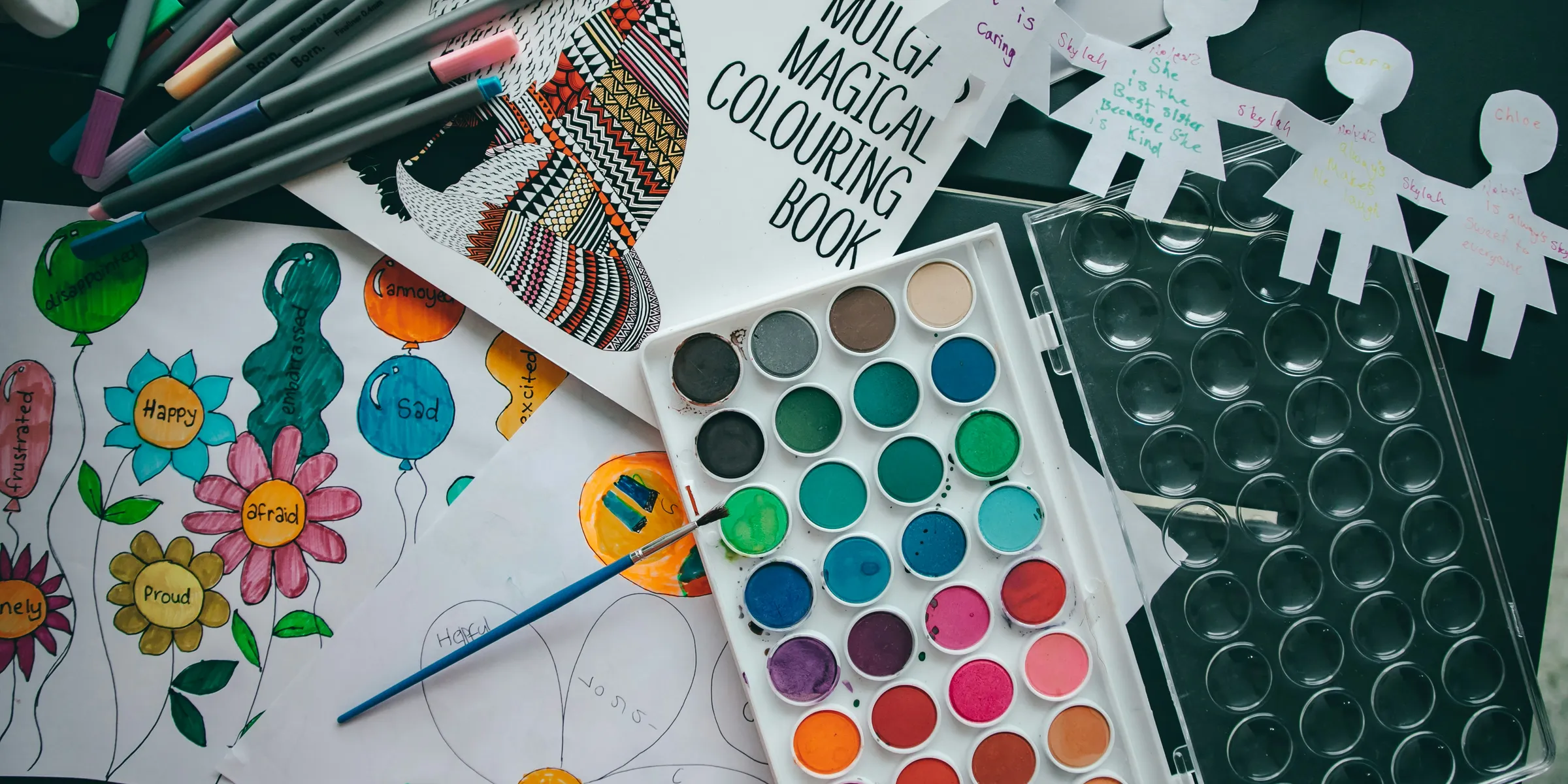 a table topped with lots of art supplies