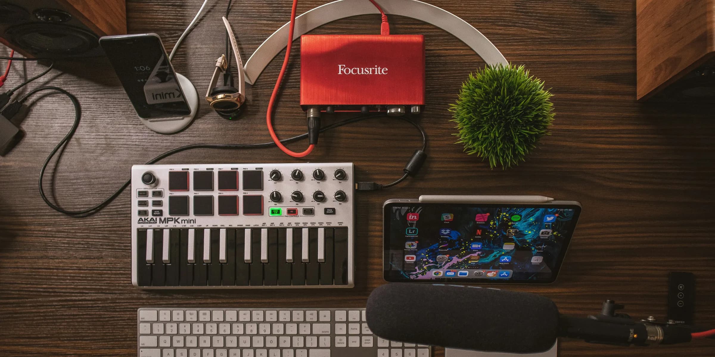 gray and black audio amplifier, silver iPad, microphone, and wireless keyboard