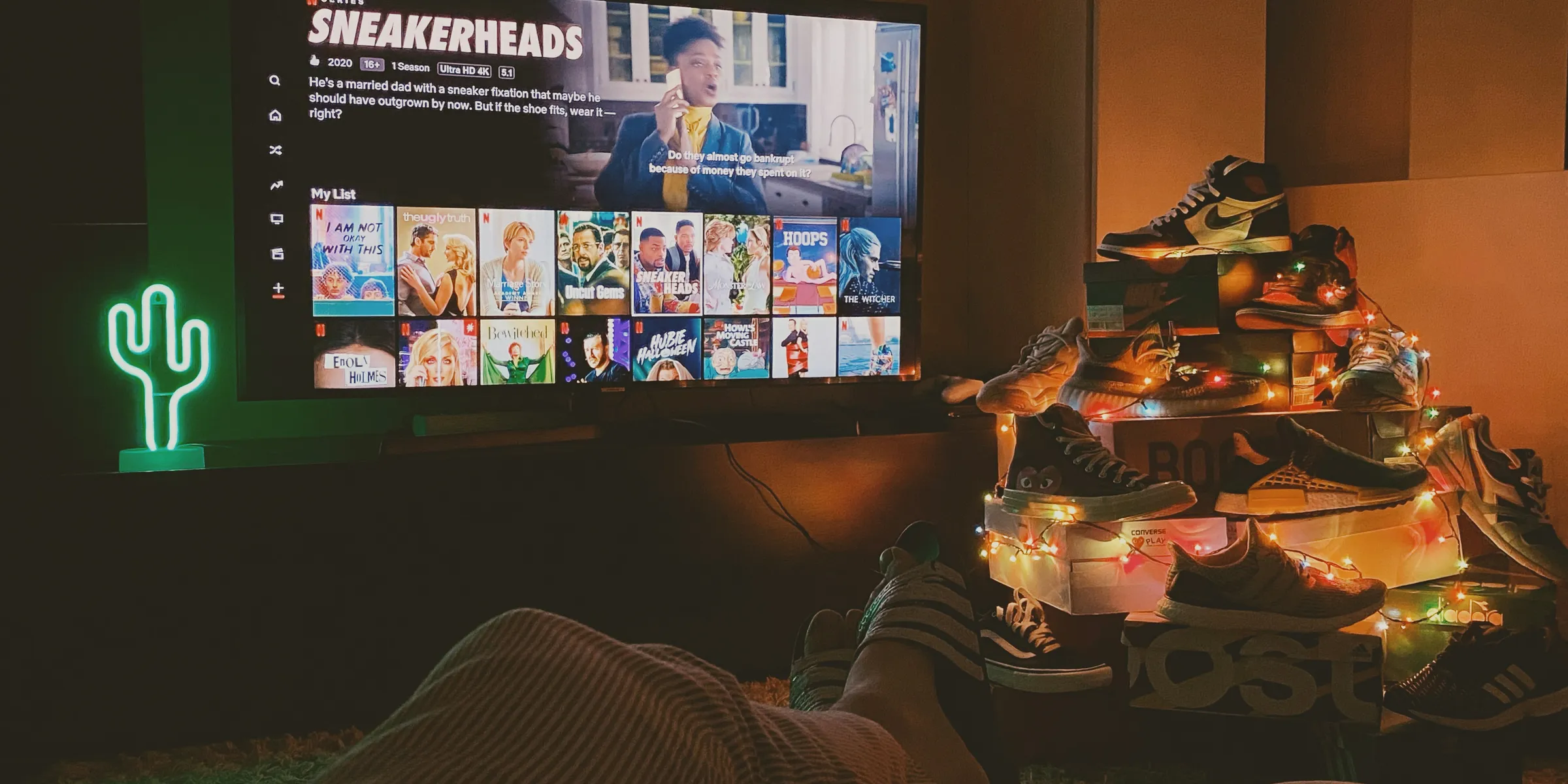 a person holding a laptop with the word netflix on the screen