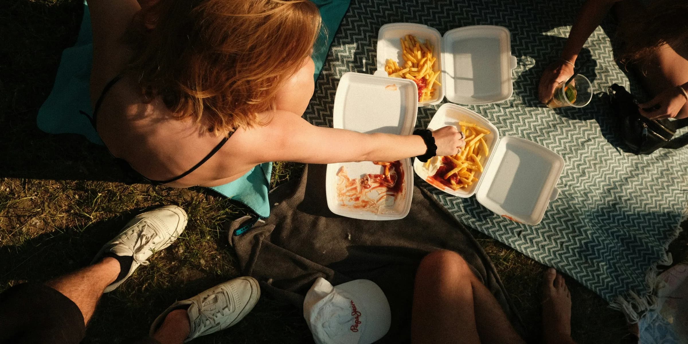 a group of people sitting around a table eating food