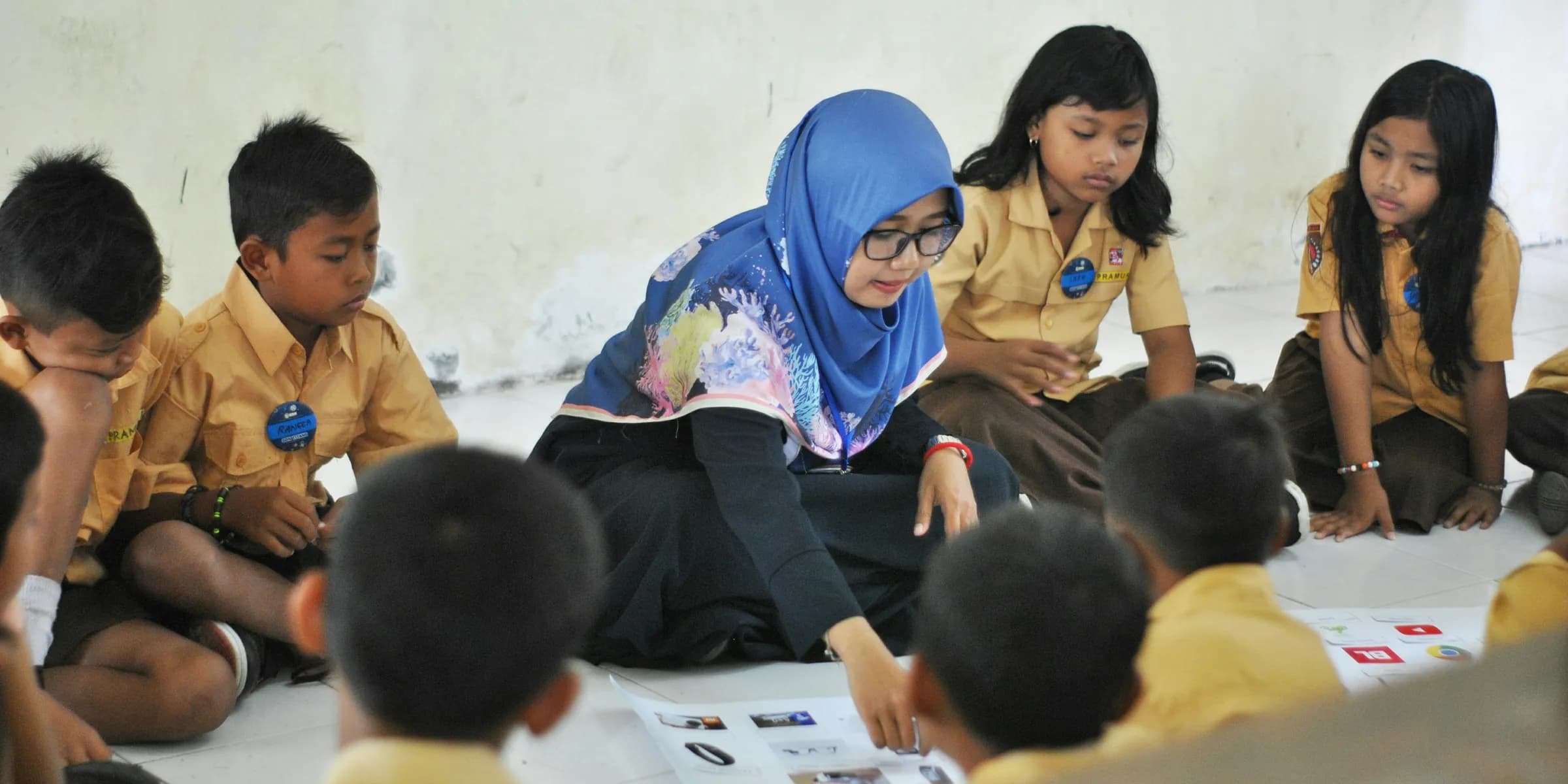 woman in blue hijab sitting on chair