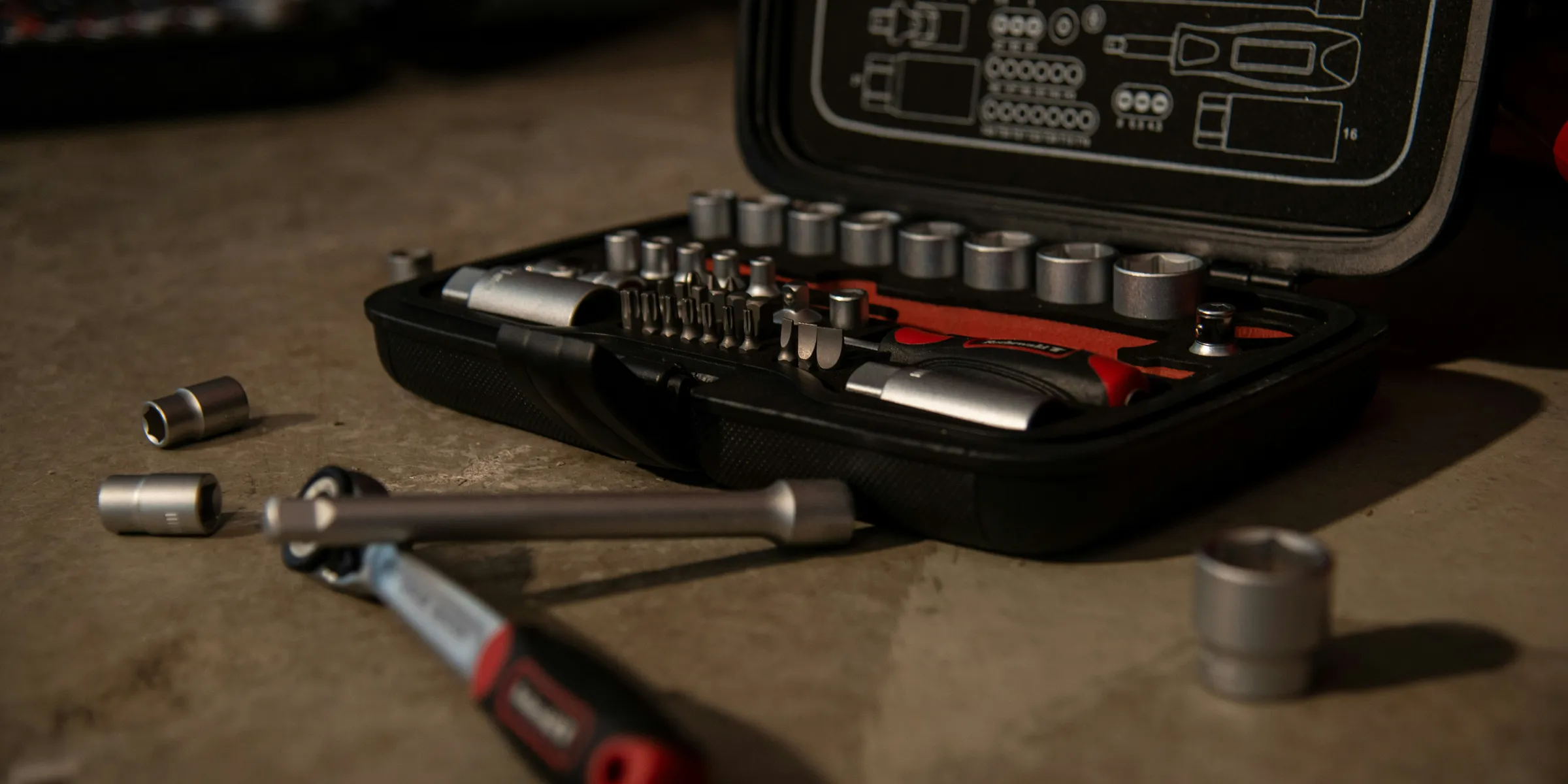 a tool kit with tools in it sitting on a table