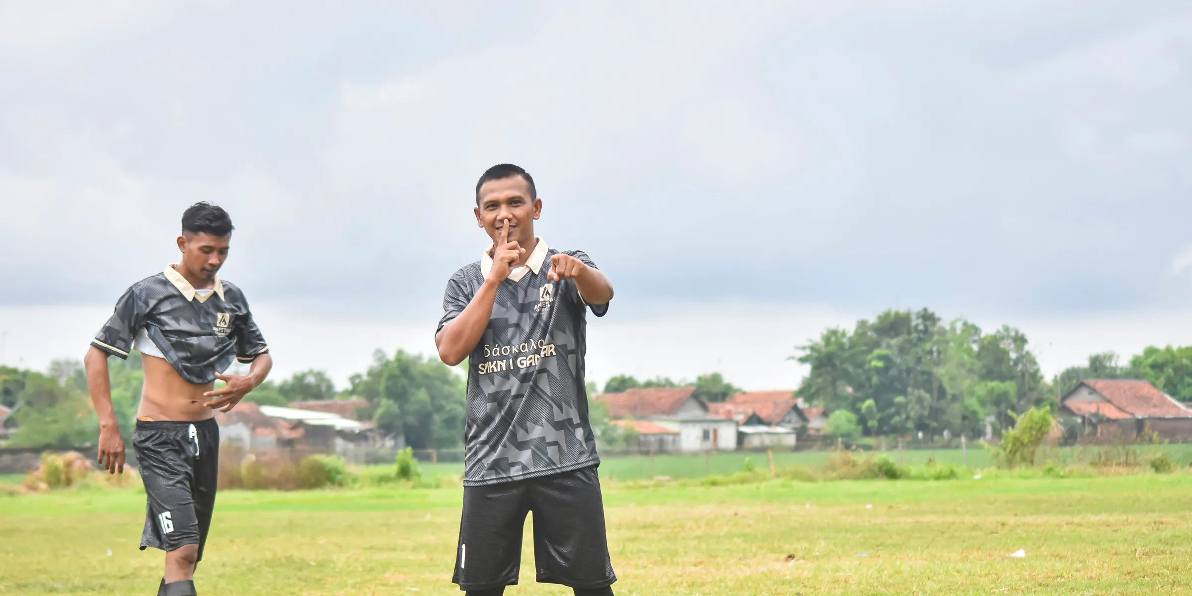 Two men in soccer uniforms on a field