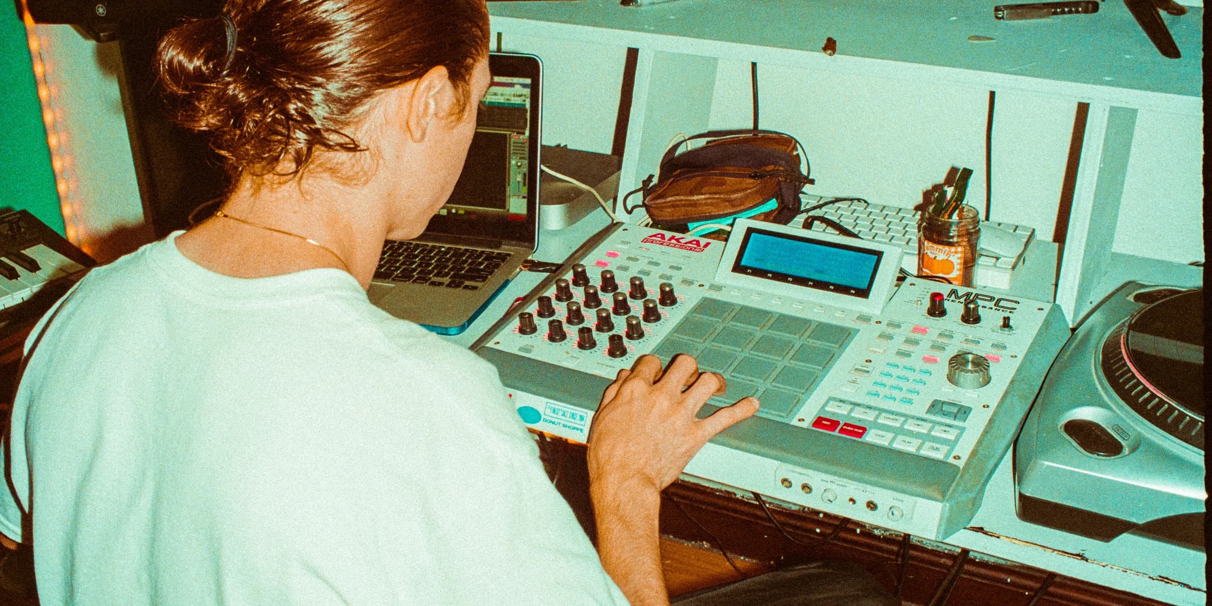 a woman sitting in front of a mixing desk