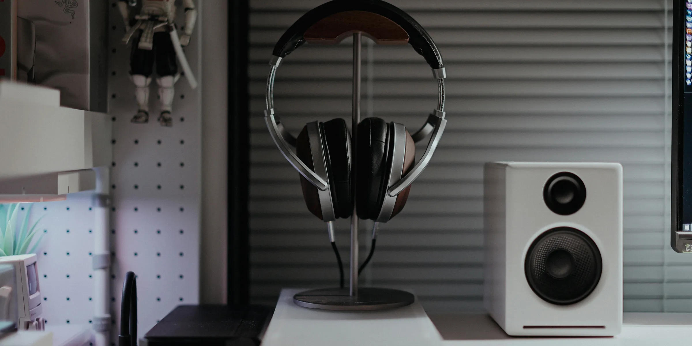 a desk with a computer and speakers on it