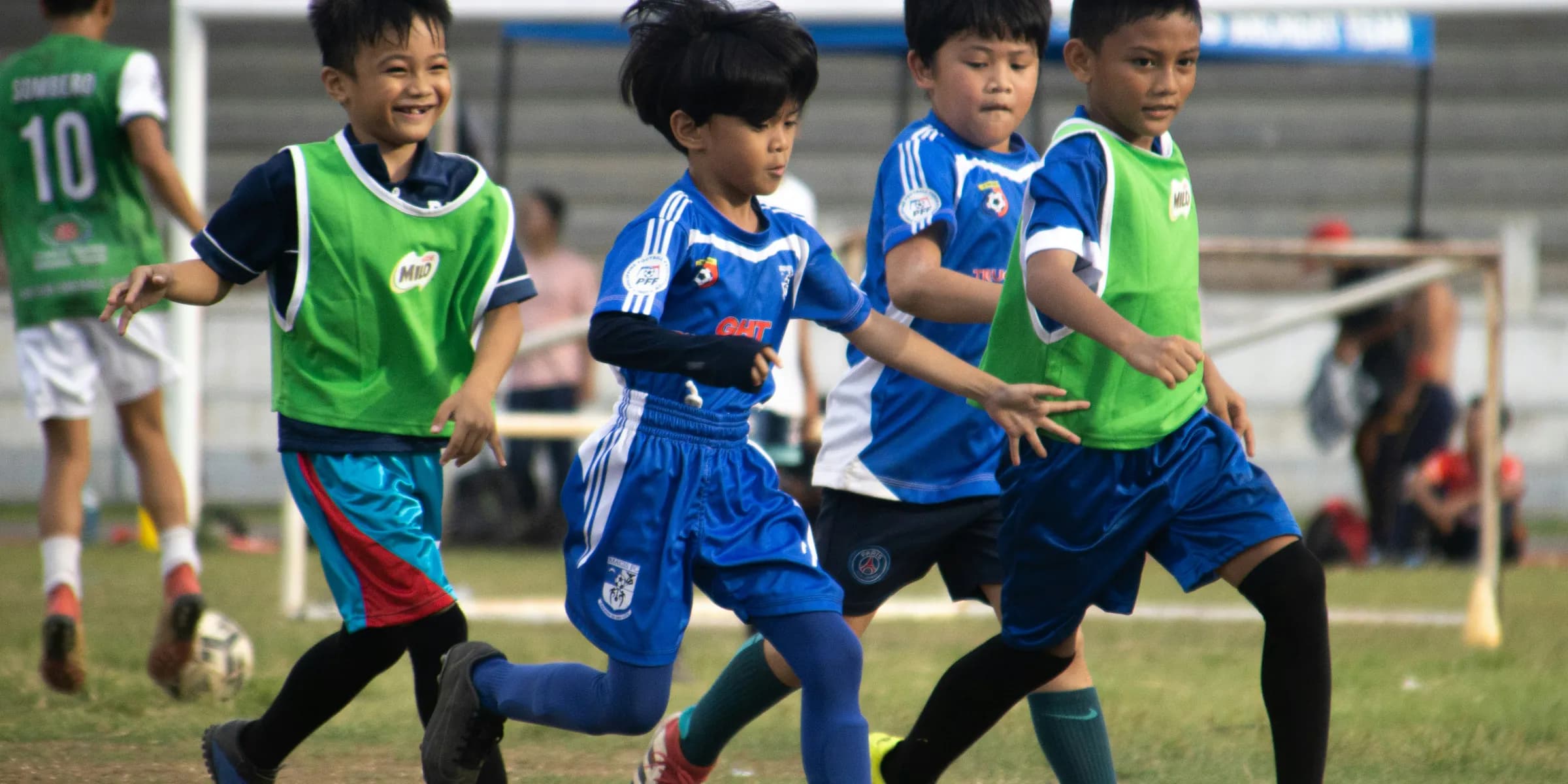 a group of young children playing a game of soccer
