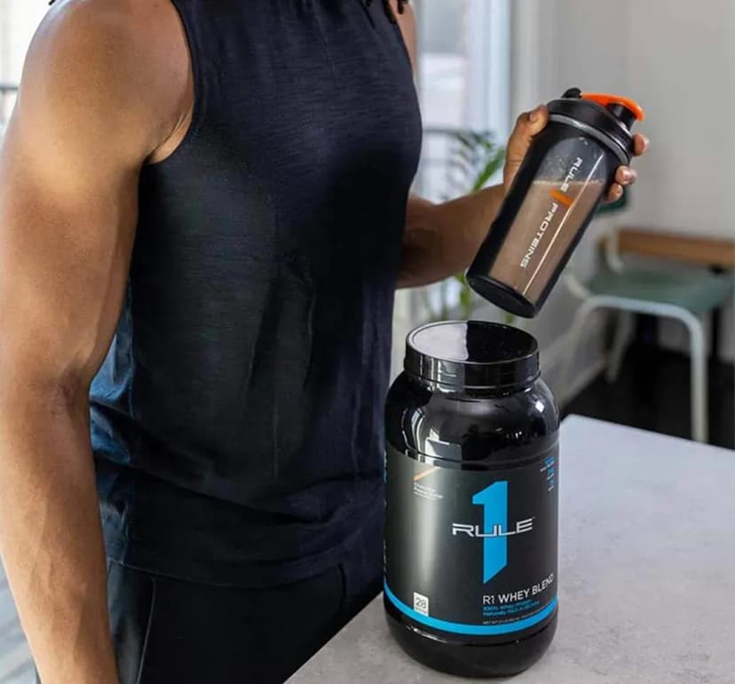 Weightlifting imagery featuring Rule 1 R1 Whey Blend