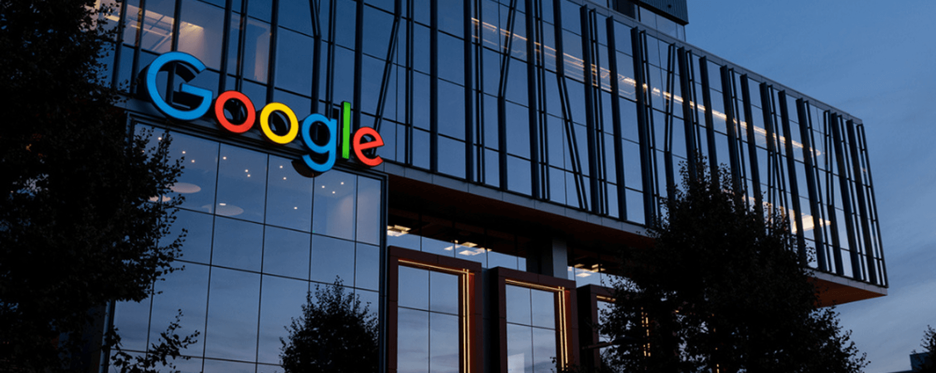 Exterior of a modern Google office building at dusk, symbolizing the origins of the peer bonus concept that inspired OnMe’s employee gifting platform.